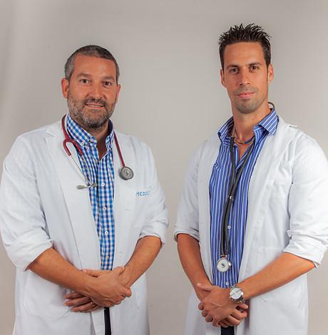 Retrato de dos doctores o profesionales médicos con batas blancas y estetoscopios.